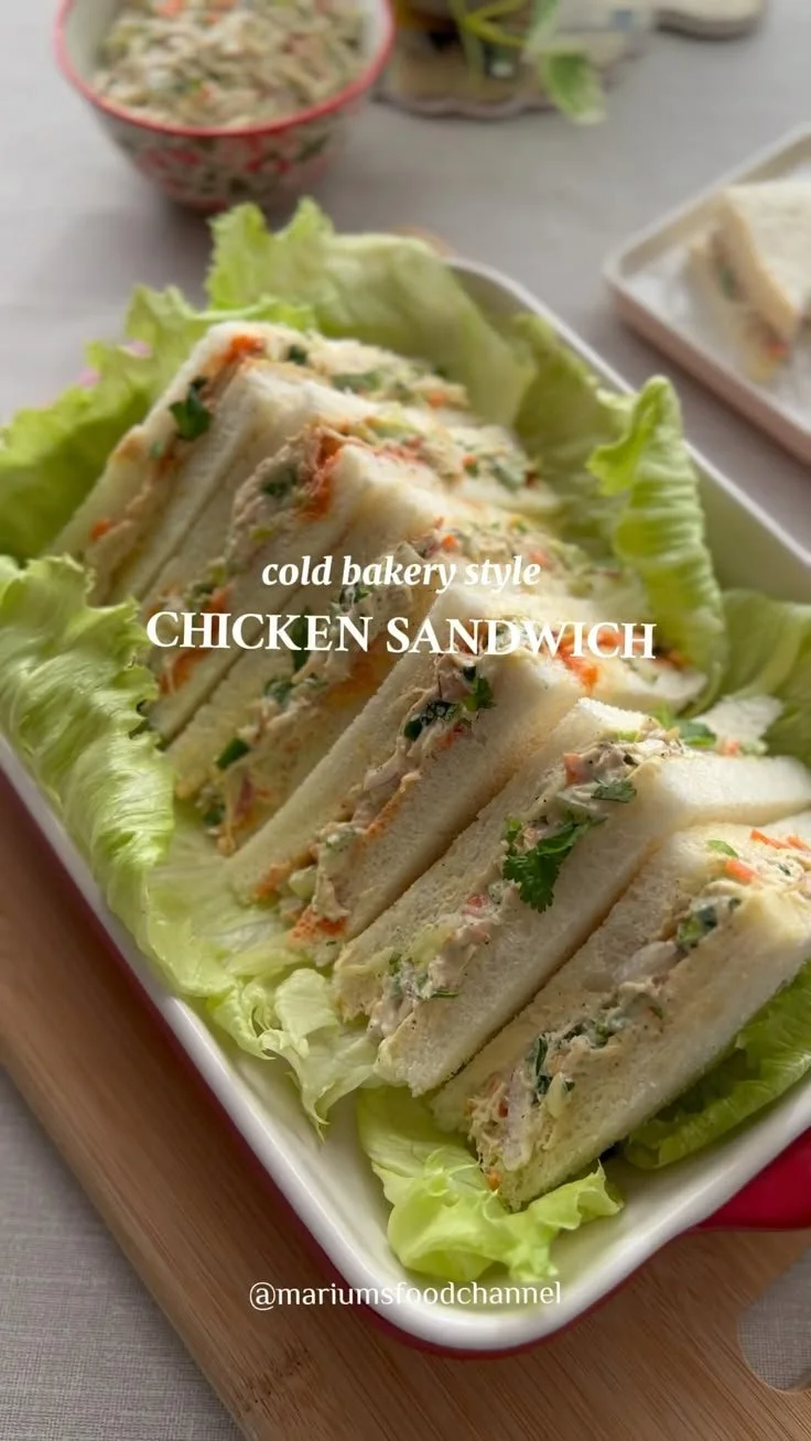 Delicious cold chicken mayo sandwich served on a plate with fresh ingredients.