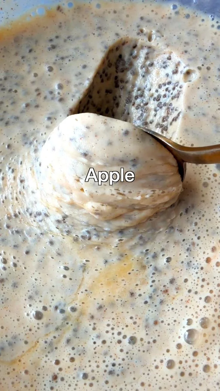 Bowl of overnight apple chia pudding topped with fresh apple slices and cinnamon