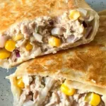 Tuna melt wrap filled with creamy tuna and melted cheese in a tortilla