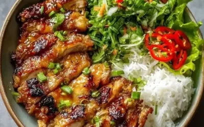 Delicious Vietnamese Lemongrass Chicken on a plate with herbs and rice